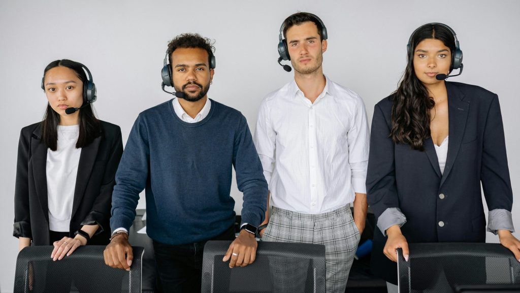 Customer service team with headsets standing in a row, ready to assist.