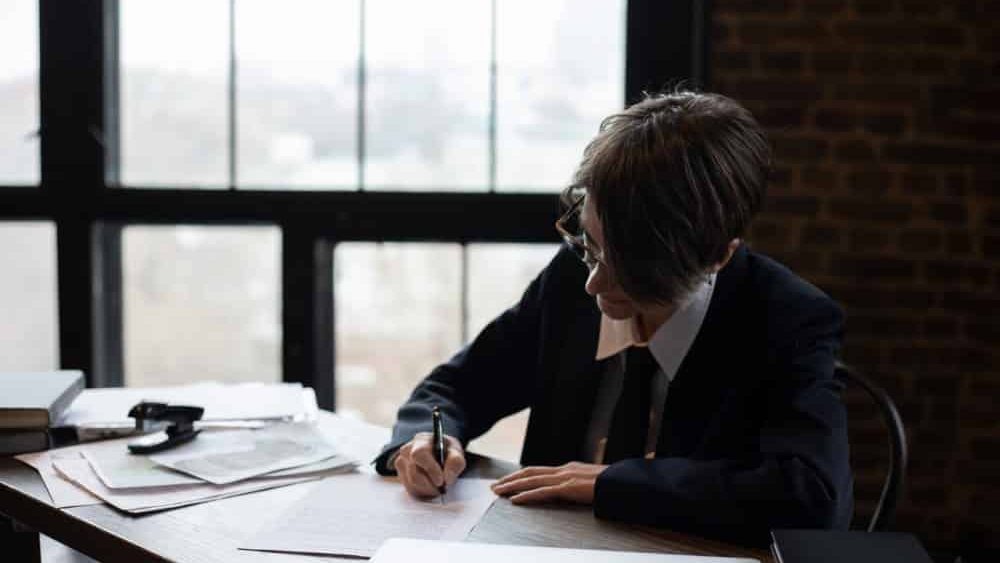 que es un family office, una persona escribe una documentacion en un despacho