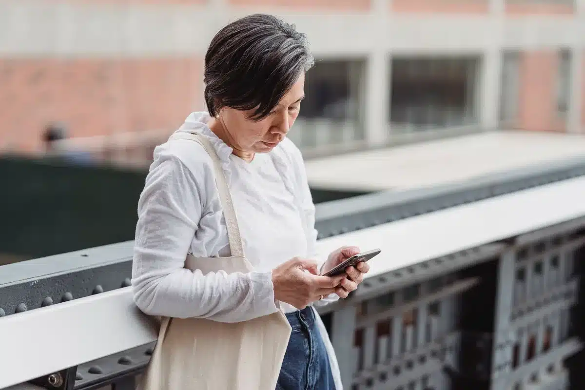 Woman checks on her phone that the fake profile is gone