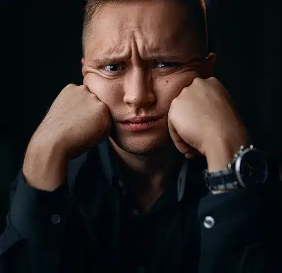 Worried man because of old information that harms him